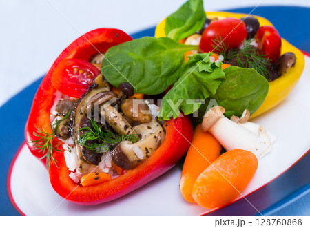Peppers stuffed with forest mushrooms, rice, vegetables, greens 128760868