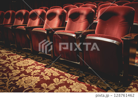 Empty red velvet seats in a vintage theater or cinema. AI generated. 128761462