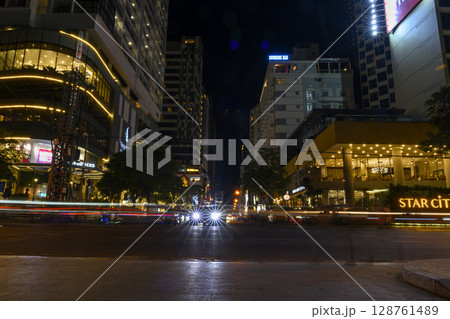 The central street of the city with restaurants, hotels and skyscrapers at night The central street of the city with restaurants, hotels and skyscrapers at night 128761489