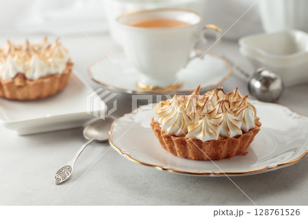 Meringue tart on a white marble countertop. 128761526
