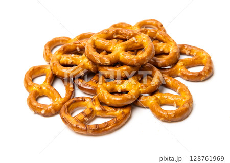 Small traditional beer pretzels with salt isolated on white background Small traditional beer pretzels with salt isolated on white background 128761969