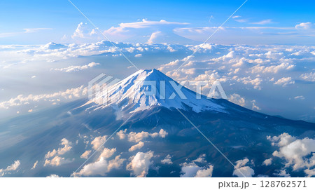 Aerial view of Mount Fuji with snow-covered peak and surrounding clouds. Ideal for concepts like nature, travel, landscape, and iconic destinations. 128762571