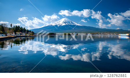 Aerial view of Mount Fuji with snow-covered peak and surrounding clouds. Ideal for concepts like nature, travel, landscape, and iconic destinations. Aerial view of Mount Fuji with snow-covered peak and surrounding clouds. Ideal for concepts like nature, travel, landscape, and iconic destinations. 128762881