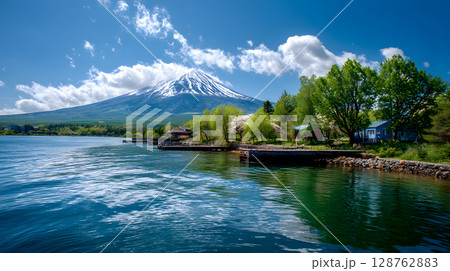 Aerial view of Mount Fuji with snow-covered peak and surrounding clouds. Ideal for concepts like nature, travel, landscape, and iconic destinations. Aerial view of Mount Fuji with snow-covered peak and surrounding clouds. Ideal for concepts like nature, travel, landscape, and iconic destinations. 128762883