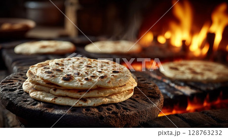 Golden Brown Flatbread Baking on a Hot Stone Oven 128763232