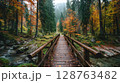 Wooden Bridge in Autumn Forest Path 128763482
