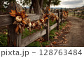 Rustic Wooden Fence Decorated with Autumnal Pumpkins and Leaves 128763484