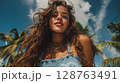Portrait of a Young Woman with Curly Brown Hair on a Tropical Beach 128763491