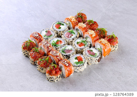 Premium Salmon Sushi Roll Set on Gray Stone Background Plate Premium Salmon Sushi Roll Set on Gray Stone Background Plate 128764389