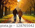 Senior couple walking hand in hand through a beautiful autumn park. Romantic retirement lifestyle, healthy aging, and love in later years concept. Image generated by AI 128765042