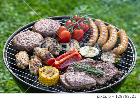 various meats and vegetables on charcoal grill various meats and vegetables on charcoal grill 128765323