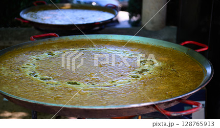 Traditional Spanish Outdoor Paella Preparation During Village Festivities Traditional Spanish Outdoor Paella Preparation During Village Festivities 128765913