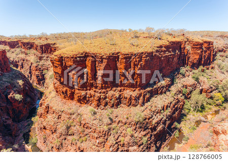 Red rock cliffs and gorge in Karijini National Park, Western Australia.. Red rock cliffs and gorge in Karijini National Park, Western Australia.. 128766005