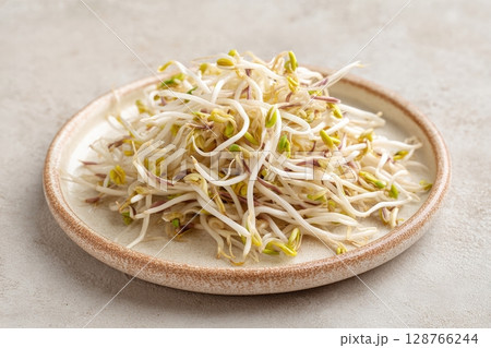 Fresh Mung Bean Sprouts on Ceramic Plate with Neutral Beige Background 128766244
