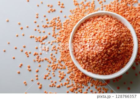 Red Lentils in White Bowl on Light Gray Background 128766357