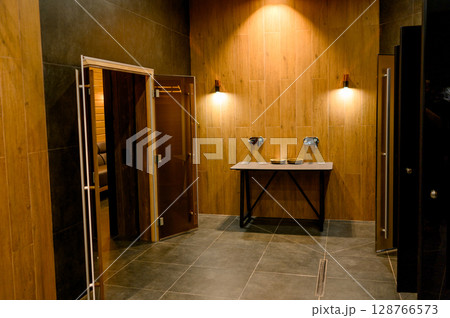Sauna interior with wooden walls and benches 128766573