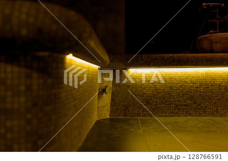 Interior of a hammam sauna with stone finishing and lighting Interior of a hammam sauna with stone finishing and lighting 128766591