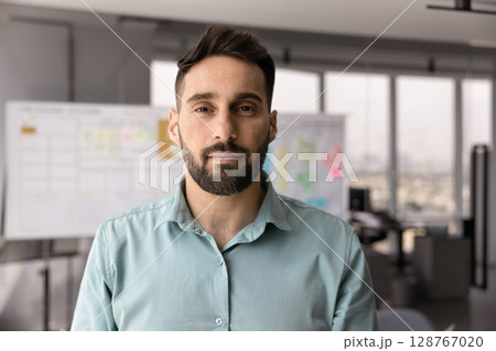 Headshot portrait of handsome, bearded Hispanic business man 128767020