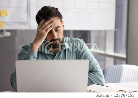 Man feels stressed due to work pressure, deadlines, challenging tasks Man feels stressed due to work pressure, deadlines, challenging tasks 128767153