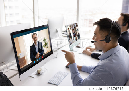 Businessmen negotiating remotely, engaged in video call Businessmen negotiating remotely, engaged in video call 128767154