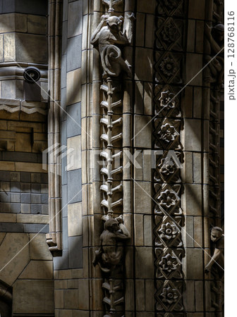 Sunlight illuminating intricate stone carvings and decorative elements on the columns and walls. Sunlight illuminating intricate stone carvings and decorative elements on the columns and walls. 128768116