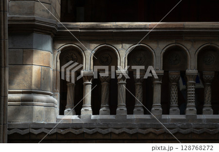 Sunlight casts dramatic shadows across stone columns and ornate stone balustrade. Sunlight casts dramatic shadows across stone columns and ornate stone balustrade. 128768272