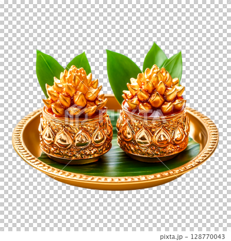 Decorative Golden Pineapple Treats with Green Leaves on a Plate for Celebration 128770043