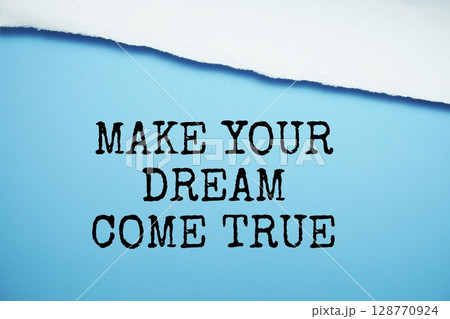 Make Your Dream Come True message written on blue paper with torn paper background 128770924