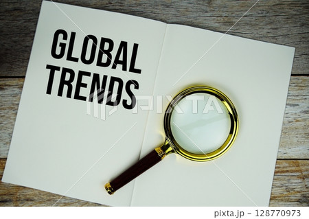 Global Trends text written on chalkboard with alarm clock on wooden background Global Trends text written on chalkboard with alarm clock on wooden background 128770973