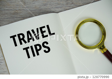 Travel Tips text written on chalkboard with alarm clock on wooden background Travel Tips text written on chalkboard with alarm clock on wooden background 128770990