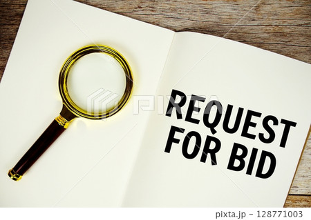 Request For Bid text written on chalkboard with alarm clock on wooden background 128771003
