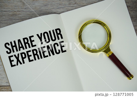 Share Your Experience text message written on paper note with magnifying glass top view on wooden background 128771005