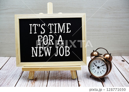 It's Time for a New Job text written on chalkboard with alarm clock on wooden background 128771030
