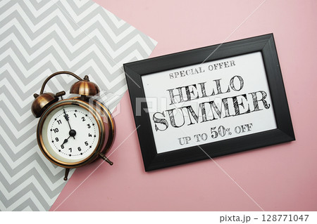 Hello Summer Sale 50% off with alarm clock on pink background 128771047