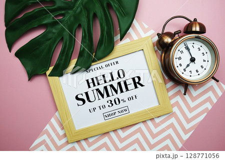Hello Summer Sale 30% off with alarm clock and monstera green leaf on pink background Hello Summer Sale 30% off with alarm clock and monstera green leaf on pink background 128771056