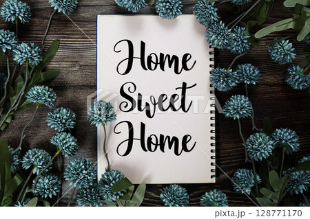 Home Sweet Home text with flowers decoration on wooden background Home Sweet Home text with flowers decoration on wooden background 128771170