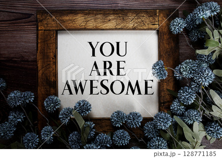 You are Awesome text with flowers decoration on wooden background You are Awesome text with flowers decoration on wooden background 128771185