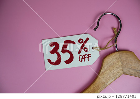 Sale 35% off price tag label with Clothes hanger Clothing Promotion shopping concept 128771403