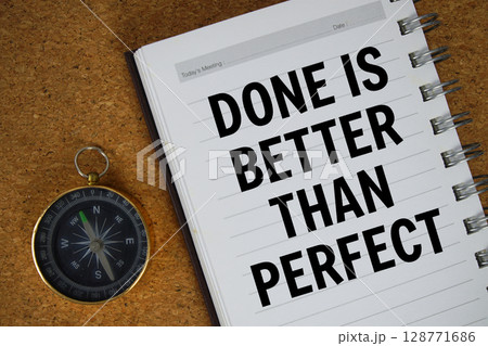 Done Is Better Than Perfect text written on notebook paper with compass 128771686