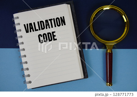 Validation Code text written on notebook paper with magnifying glass 128771773