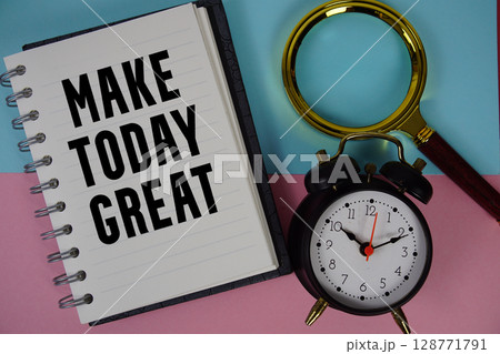 Make Today Great text written on notebook paper with magnifying glass and alarm clock 128771791