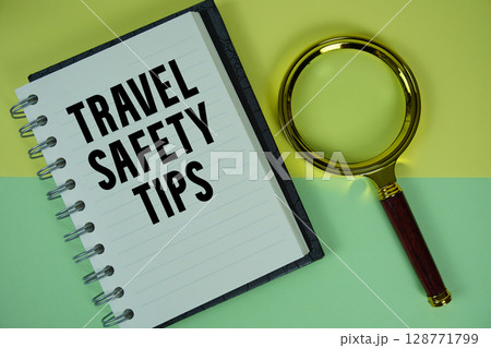 Travel Safety Tips text written on notebook paper with magnifying glass Travel Safety Tips text written on notebook paper with magnifying glass 128771799