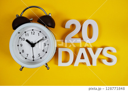 20 Days alphabet letters with alarm clock on yellow background 20 Days alphabet letters with alarm clock on yellow background 128771848