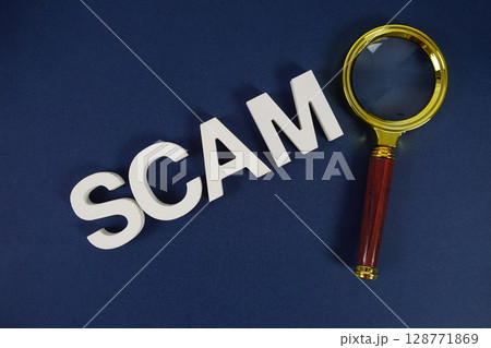 Scam letters with magnifying glass flat lay on blue background Scam letters with magnifying glass flat lay on blue background 128771869