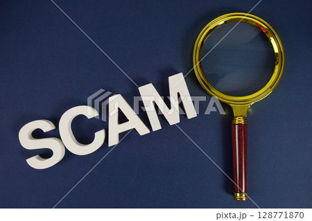 Scam letters with magnifying glass flat lay on blue background Scam letters with magnifying glass flat lay on blue background 128771870