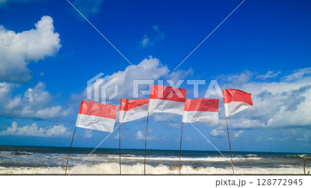 Indonesia asia flags on the beach with beautiful blue sky. Independen day and summer vacation concept  128772945