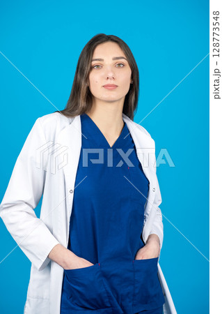 Brunette long hair woman doctor portrait in medicine suit Brunette long hair woman doctor portrait in medicine suit 128773548
