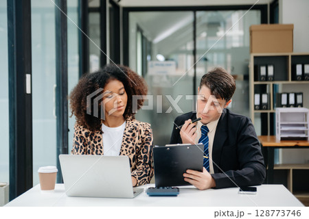 Portrait of success business people working together in home office. Couple teamwork startup concept Portrait of success business people working together in home office. Couple teamwork startup concept 128773746