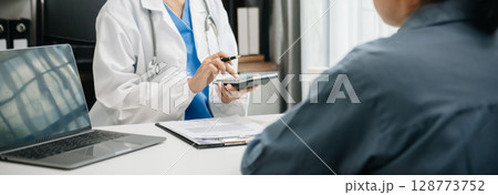 Healthcare costs and fees concept.Hand of smart doctor used a calculator and smartphone, tablet for medical costs at hospital Healthcare costs and fees concept.Hand of smart doctor used a calculator and smartphone, tablet for medical costs at hospital 128773752