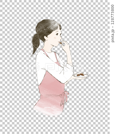 家事の合間にお菓子をつまむエプロン姿の女性 128773800